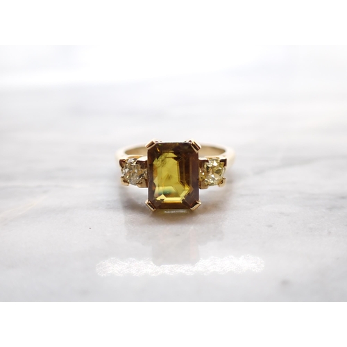 287 - A Zircon and Diamond three stone Ring corner claw-set yellow/brown zircon between two old-cut diamon... 