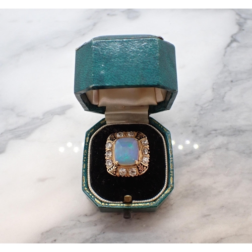 290 - An Opal, Diamond and Enamel Ring corner claw-set rectangular opal cabochon within a frame of ten old... 