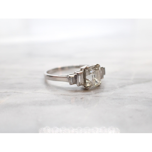 293 - A Diamond Ring corner claw-set asscher-cut stone, estimated 1.20ct, between two pairs of baguettes i... 