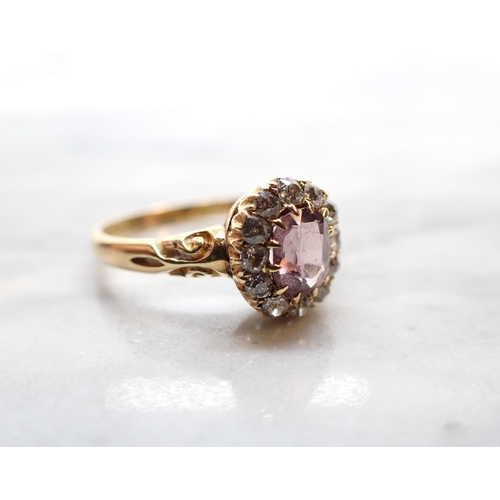 295 - A Victorian Pink Spinel and Diamond Cluster Ring claw-set oval-cut spinel within a frame of old-cut ... 