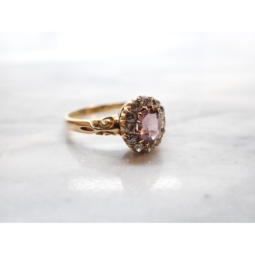 295 - A Victorian Pink Spinel and Diamond Cluster Ring claw-set oval-cut spinel within a frame of old-cut ... 