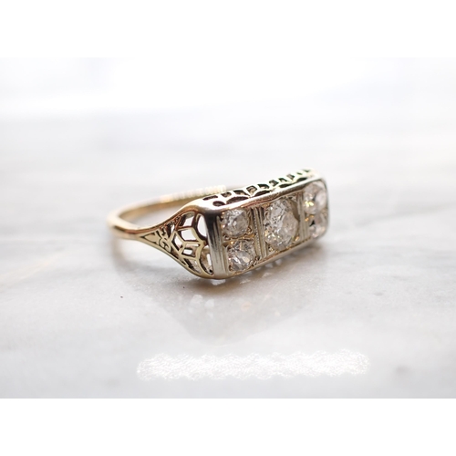 297 - A Diamond five stone Ring pavé-set old-cut stone (chipped) between two pairs of smaller stones, stam... 