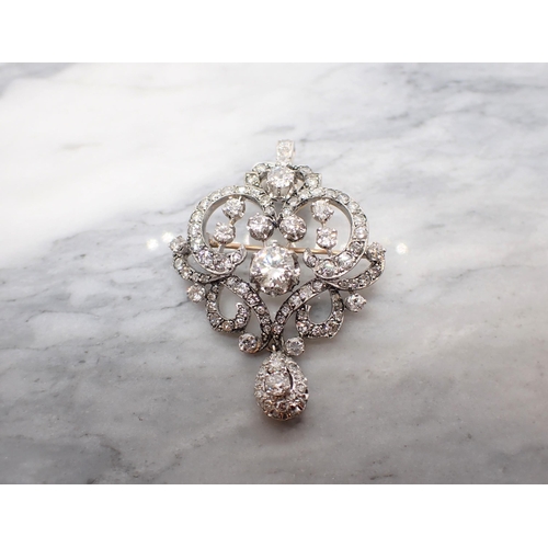 307 - A Belle Époque Diamond Pendant/Brooch the openwork scrolled plaque claw-set principle brilliant-cut ... 