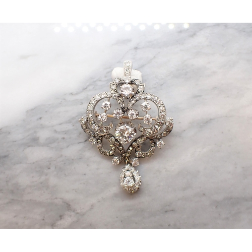 307 - A Belle Époque Diamond Pendant/Brooch the openwork scrolled plaque claw-set principle brilliant-cut ... 