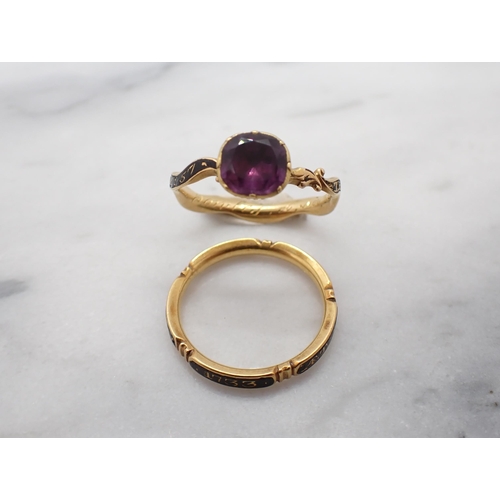 308 - An 18th Century Amethyst Memoriam Ring close-set round foil-backed stone on scrolled shank inlaid bl... 