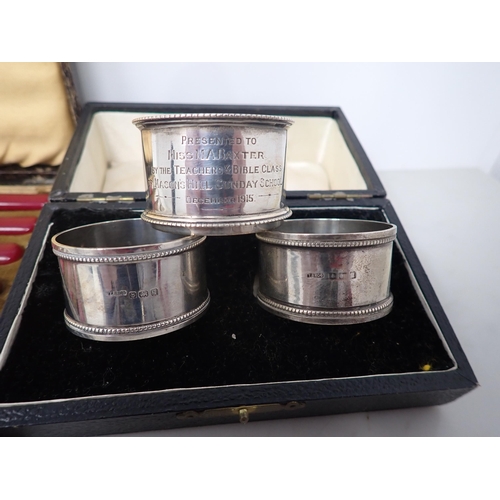 32 - A heavy silver presentation Napkin Ring, Birmingham 1915, 72gms, a pair of Napkin Rings, Birmingham ... 