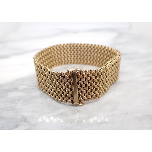 320 - A 9ct gold wide woven effect Bracelet, 18cms long, approx 40.40gms