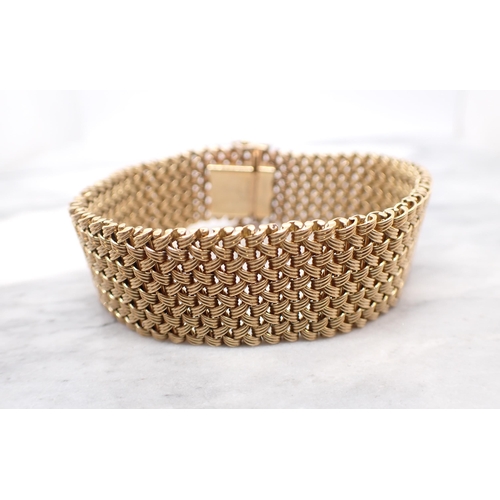 320 - A 9ct gold wide woven effect Bracelet, 18cms long, approx 40.40gms