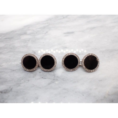 322 - A pair of circular Black Onyx and Diamond Cufflinks each set onyx within a frame of millegrain-set r... 