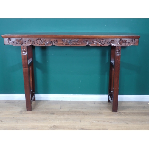 386 - A Chinese hardwood Altar Table with carved scroll, leafage and fruit designs to the rails on tall su... 