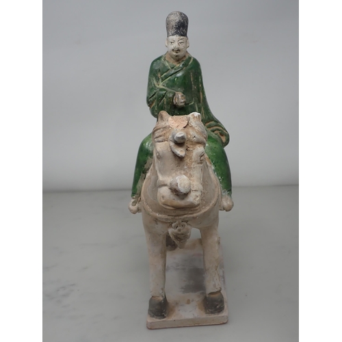 389 - A green glazed Figure on horseback, possibly late Ming dynasty, 12in H, and two similar figures, 8½ ... 