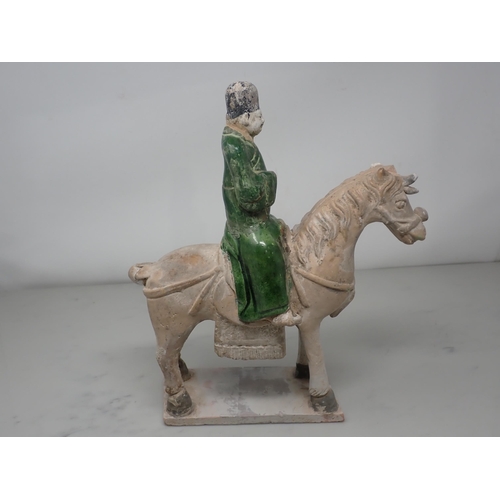 389 - A green glazed Figure on horseback, possibly late Ming dynasty, 12in H, and two similar figures, 8½ ... 