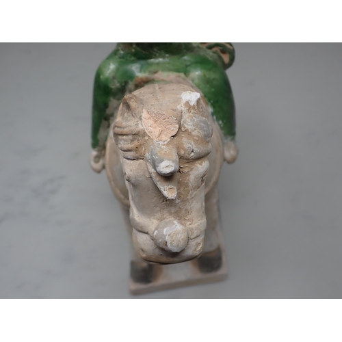 389 - A green glazed Figure on horseback, possibly late Ming dynasty, 12in H, and two similar figures, 8½ ... 