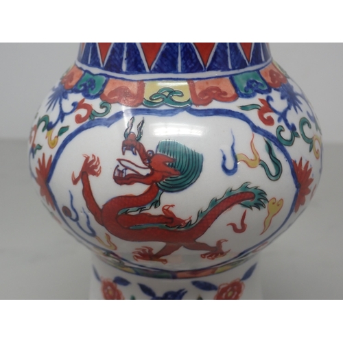 392 - A Chinese Doucai Vase with flared rim, tapering to the neck with bulbous body and spreading foot, de... 