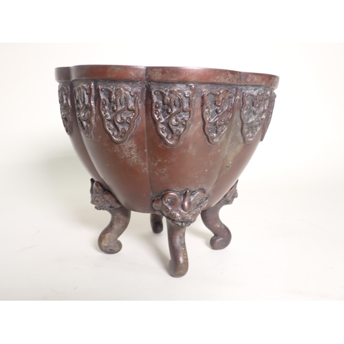 395 - An Oriental bronze Jardiniere of lobed design, raised on four scrolled supports with dragon masks, 6... 