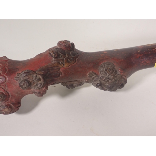 396 - An Oriental carved faux bamboo stick, carved sage to the handle, 3ft 11in L