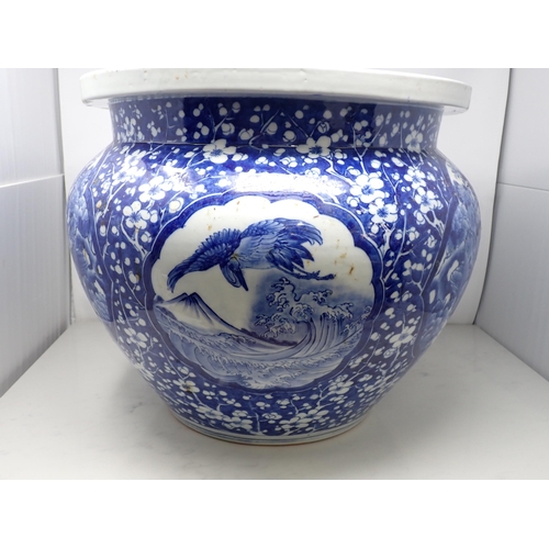 401 - A large Chinese blue and white Fish Bowl with reserves of birds amongst flowering shrubs, prunus sur... 