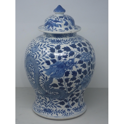 409 - A Chinese blue and white Jar and Cover of baluster form decorated dragons amongst flowers, 15in H, A... 