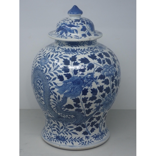 409 - A Chinese blue and white Jar and Cover of baluster form decorated dragons amongst flowers, 15in H, A... 