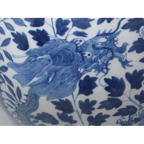 409 - A Chinese blue and white Jar and Cover of baluster form decorated dragons amongst flowers, 15in H, A... 