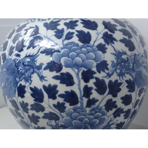 409 - A Chinese blue and white Jar and Cover of baluster form decorated dragons amongst flowers, 15in H, A... 