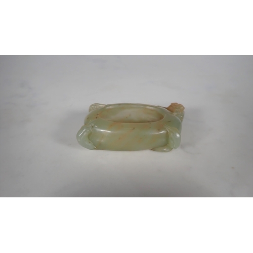 411 - A Chinese Jade Brush Washer of oval form carved flower and leaves, approx 3in wide