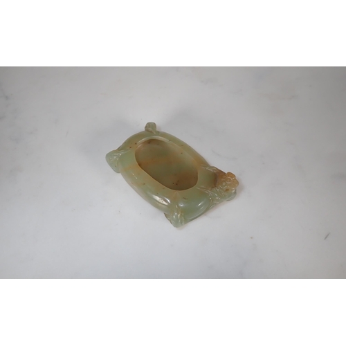 411 - A Chinese Jade Brush Washer of oval form carved flower and leaves, approx 3in wide