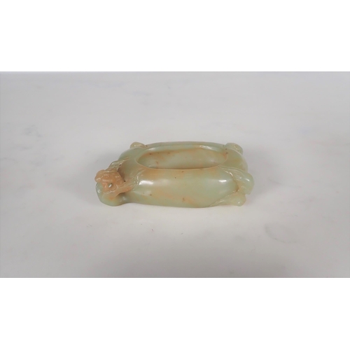 411 - A Chinese Jade Brush Washer of oval form carved flower and leaves, approx 3in wide