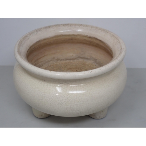 417A - A Chinese ceramic Pot with wooden cover and three peg supports, 8in diam.