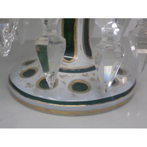 419 - A pair of Victorian green glass Table Lustres, overlaid with opaque glass with prismatic pendant dro... 