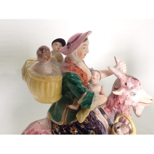 421 - A pair of 19th Century Derby Figures of The Welsh Tailor and his Wife, each figure riding a goat, th... 