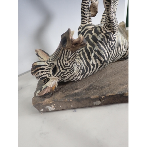 451 - PIERRE DIAMANTOPOULO. A stoneware Model of a Zebra lying on its back, and mounted on a stone plinth,... 