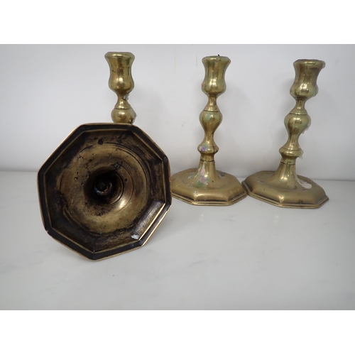 465 - A set of four antique brass Candlesticks with baluster columns on octagonal bases, 6in