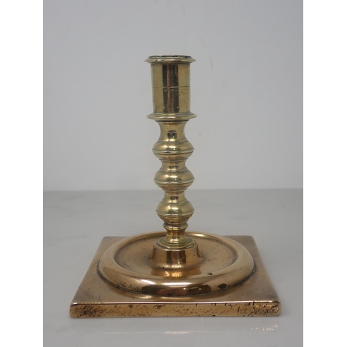 475 - A Georgian brass Candlestick with knopped stem and square base, 5½in H