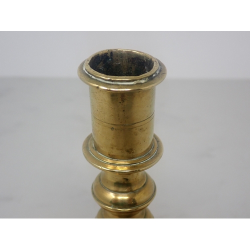 475 - A Georgian brass Candlestick with knopped stem and square base, 5½in H