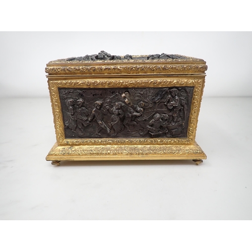 477 - A 19th Century French gilt-metal and bronzed Casket, the inset panels decorated figures merrymaking,... 