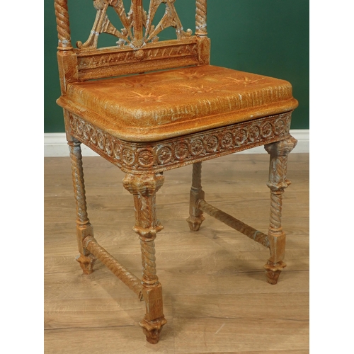 486A - A Coalbrookdale cast iron Chair designed by Christopher Dresser, with pierced back, cast simulated b... 