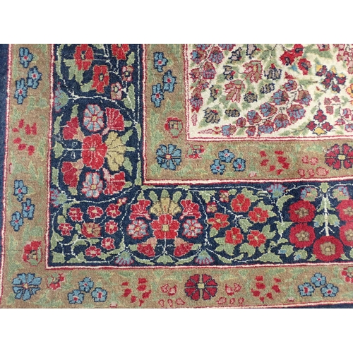 500 - A fine quality Persian Rug with floral designs two the borders, and central oval depicting vase of f... 