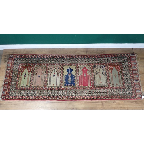 505 - A Persian Prayer Rug, multi-bordered and with seven mihrabs of differing designs, 7ft 9in L x 2ft 11... 