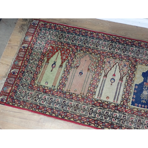 505 - A Persian Prayer Rug, multi-bordered and with seven mihrabs of differing designs, 7ft 9in L x 2ft 11... 