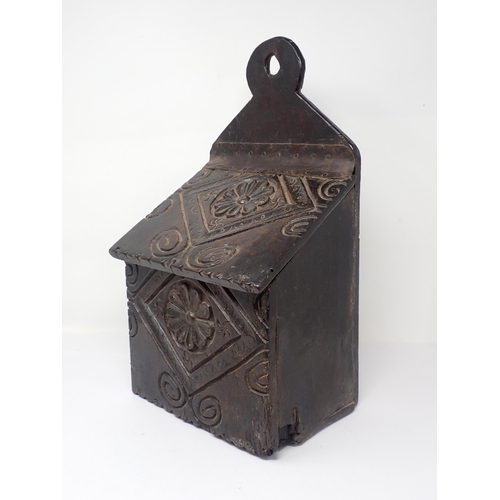 538 - An early 18th Century oak Candle Box with rosette carved sloping lid and front 1ft 4in H x 9in W