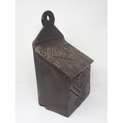 538 - An early 18th Century oak Candle Box with rosette carved sloping lid and front 1ft 4in H x 9in W