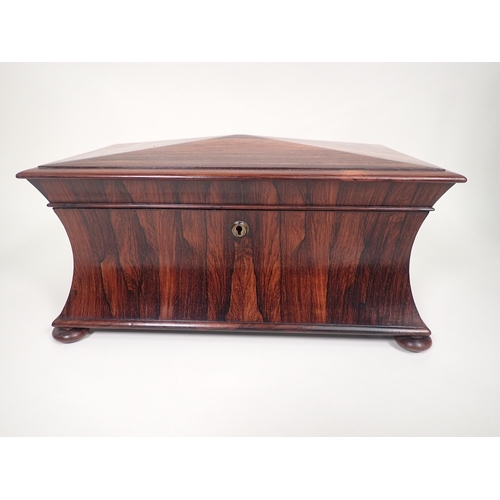 552 - A 19th Century rosewood Tea Caddy of sarcophagus shape, with interior lidded boxes, ring handles on ... 