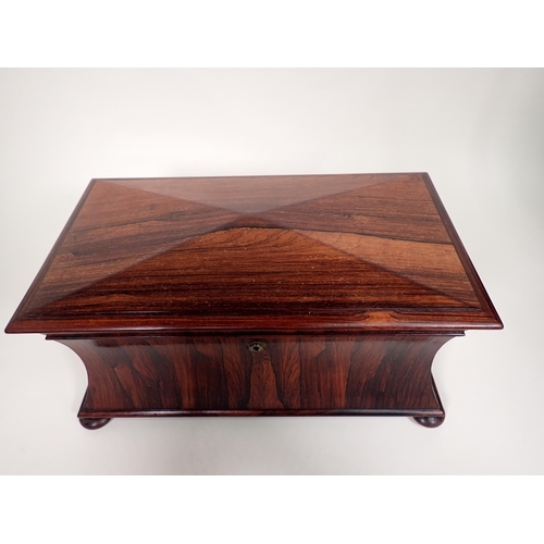 552 - A 19th Century rosewood Tea Caddy of sarcophagus shape, with interior lidded boxes, ring handles on ... 