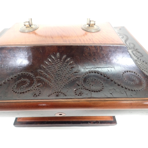 553 - A Regency mixed wood Casket of sarcophagus shape with cut steel decoration of scrolls and fans, bras... 