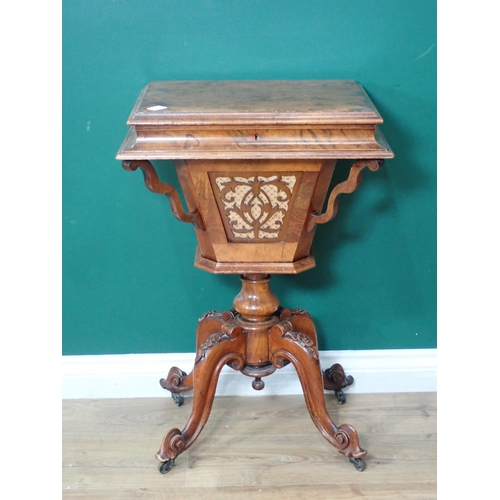 561 - A Victorian walnut Sewing Table with moulded hinged top enclosing compartments, some with fret carve... 