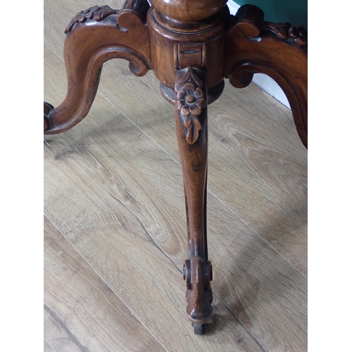 561 - A Victorian walnut Sewing Table with moulded hinged top enclosing compartments, some with fret carve... 