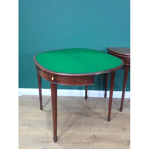 571 - A pair of 19th Century mahogany demi-lune Card Tables with moulded fold-over tops and green baise li... 