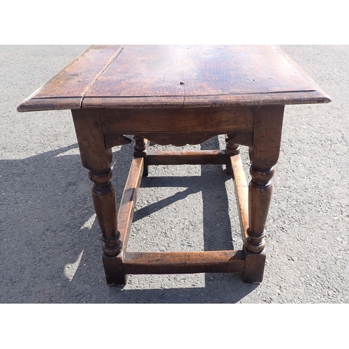 572 - An antique oak Refectory Table in the 17th Century style with moulded top above a shaped and channel... 