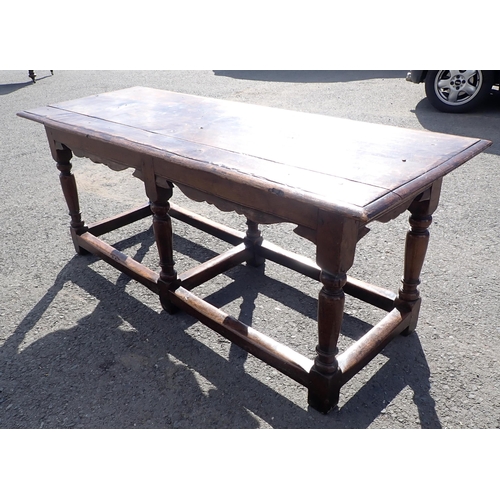 572 - An antique oak Refectory Table in the 17th Century style with moulded top above a shaped and channel... 